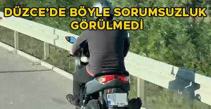 BEBEĞİ AKAN TRAFİKTE MOTOSİKLETİN ÖNÜNDE TAŞIDI